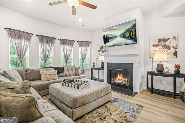 361 Traditions Ln, Hampton, GA 30228 - living area with ceiling fan, light wood finished floors, a glass covered fireplace, and recessed lighting
