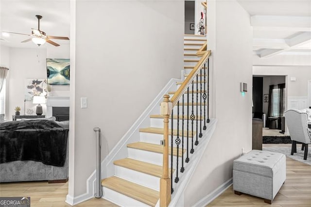 361 Traditions Ln, Hampton, GA 30228 - stairway featuring a ceiling fan, wood finished floors, coffered ceiling, and beam ceiling