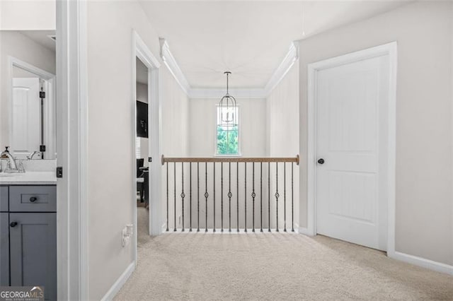 361 Traditions Ln, Hampton, GA 30228 - hall featuring carpet, baseboards, crown molding, a chandelier, and a sink