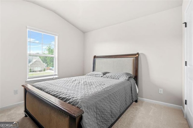 361 Traditions Ln, Hampton, GA 30228 - bedroom featuring lofted ceiling, light carpet, and baseboards