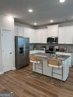 4265 SW Notting Hill Dr Unit 51, Atlanta, GA 30331 - kitchen featuring stainless steel appliances, white cabinets, a breakfast bar area, dark wood finished floors, and recessed lighting