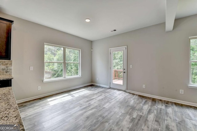 7760 Hansel Ln, Lithonia, GA 30058 - unfurnished living room with light wood-type flooring, baseboards, and a fireplace