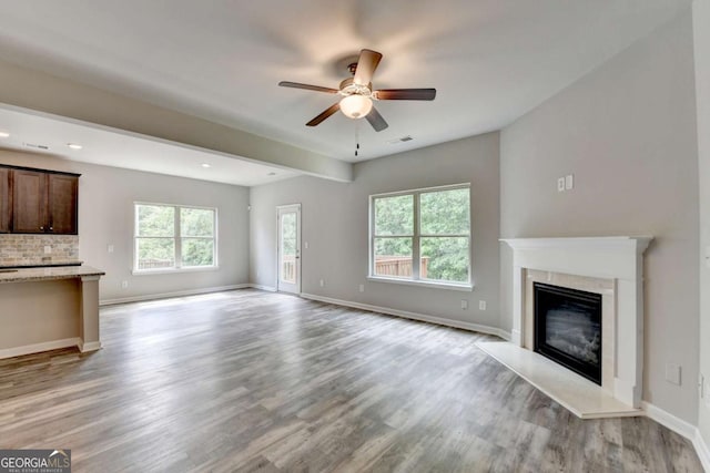 7760 Hansel Ln, Lithonia, GA 30058 - unfurnished living room featuring a ceiling fan, light wood-style floors, a premium fireplace, baseboards, and recessed lighting