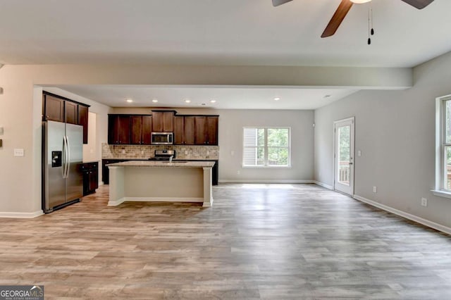 7760 Hansel Ln, Lithonia, GA 30058 - kitchen featuring stainless steel appliances, open floor plan, light wood-type flooring, a ceiling fan, and recessed lighting