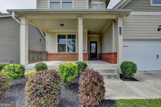 7760 Hansel Ln, Lithonia, GA 30058 - entrance to property with brick siding, a porch, and a garage