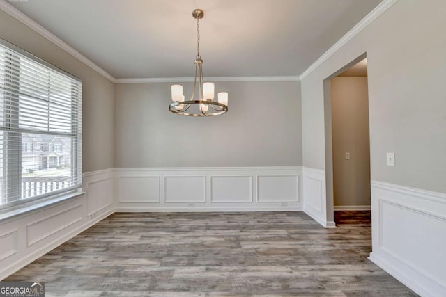 7760 Hansel Ln, Lithonia, GA 30058 - empty room featuring a chandelier, wood finished floors, crown molding, and wainscoting