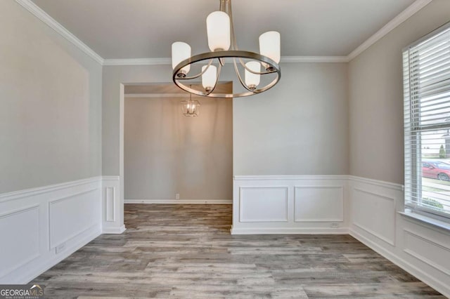 7760 Hansel Ln, Lithonia, GA 30058 - spare room featuring a chandelier, ornamental molding, wood finished floors, and a wainscoted wall