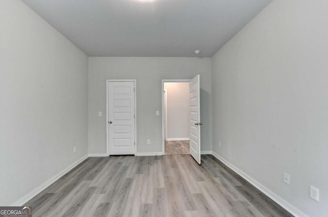7760 Hansel Ln, Lithonia, GA 30058 - unfurnished bedroom with light wood-type flooring and baseboards