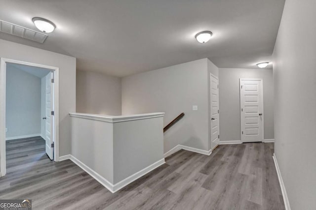 7760 Hansel Ln, Lithonia, GA 30058 - corridor with an upstairs landing, wood finished floors, and baseboards