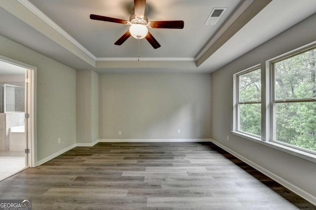 7760 Hansel Ln, Lithonia, GA 30058 - empty room featuring a raised ceiling, wood finished floors, ceiling fan, baseboards, and crown molding