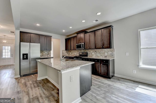 7760 Hansel Ln, Lithonia, GA 30058 - kitchen featuring stainless steel appliances, a sink, dark brown cabinets, light wood-type flooring, and recessed lighting