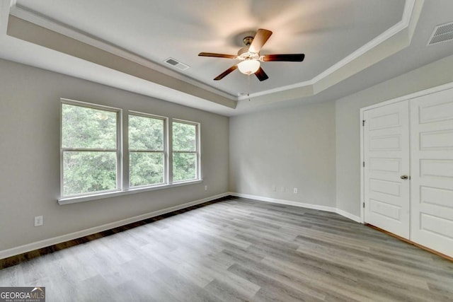 7760 Hansel Ln, Lithonia, GA 30058 - spare room with a raised ceiling, ceiling fan, wood finished floors, crown molding, and baseboards