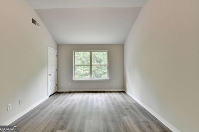 7760 Hansel Ln, Lithonia, GA 30058 - unfurnished room featuring wood finished floors, baseboards, and lofted ceiling