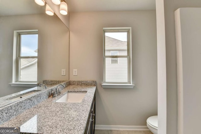 7760 Hansel Ln, Lithonia, GA 30058 - bathroom with toilet, vanity, and baseboards