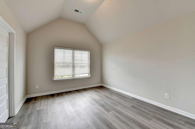 7760 Hansel Ln, Lithonia, GA 30058 - unfurnished room with wood finished floors, lofted ceiling, and baseboards