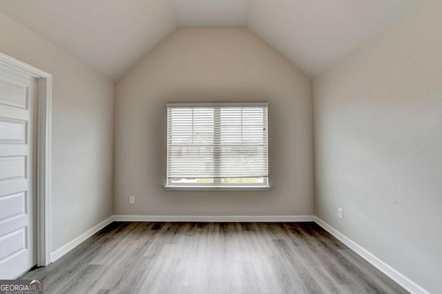 7760 Hansel Ln, Lithonia, GA 30058 - unfurnished room with wood finished floors, baseboards, and vaulted ceiling