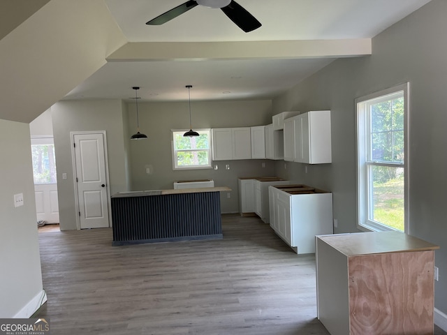 8035 Buffet Trl, Riverdale, GA 30296 - kitchen featuring light wood-style flooring, white cabinets, a center island, and ceiling fan