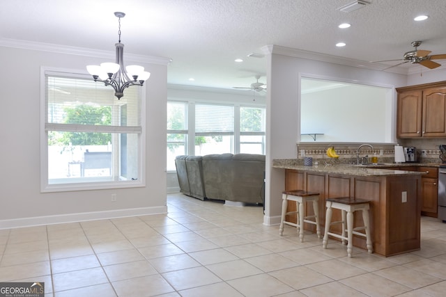 276 Laurel Landing Blvd, Kingsland, GA 31548 - kitchen featuring ceiling fan, ornamental molding, a breakfast bar, a sink, and a peninsula