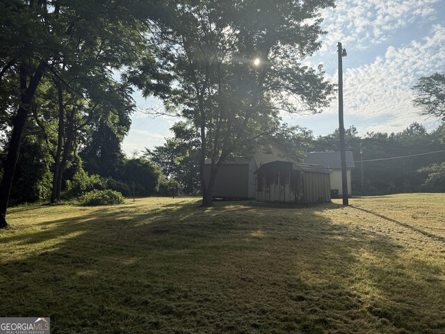 7779 Mill St SW, Cave Spring, GA 30124 - view of green lawn featuring an outbuilding