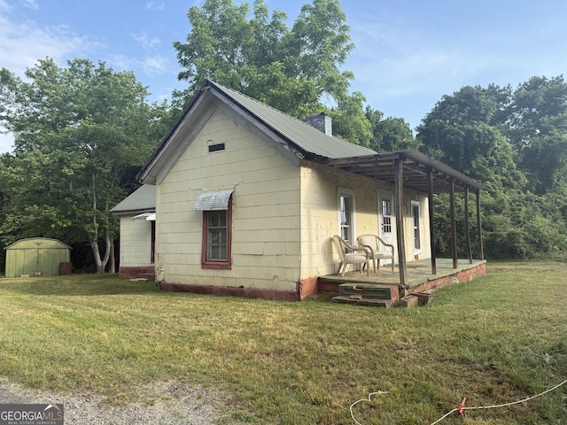 7779 Mill St SW, Cave Spring, GA 30124 - view of home's exterior with a yard and metal roof