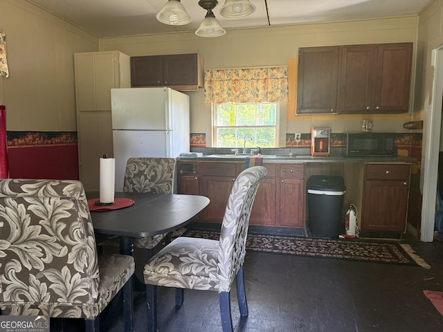 7779 Mill St SW, Cave Spring, GA 30124 - kitchen featuring black microwave, freestanding refrigerator, and a sink