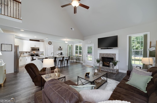 433 Wilson Dr, Mcdonough, GA 30252 - living room featuring high vaulted ceiling, ceiling fan, dark wood-type flooring, a brick fireplace, and recessed lighting