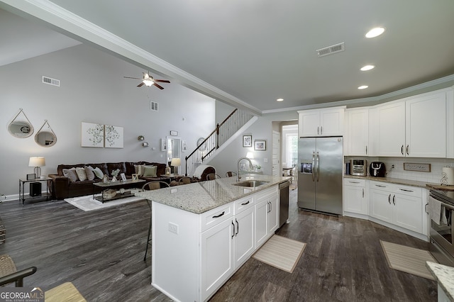 433 Wilson Dr, Mcdonough, GA 30252 - kitchen featuring appliances with stainless steel finishes, dark wood-style flooring, light stone countertops, recessed lighting, and ornamental molding
