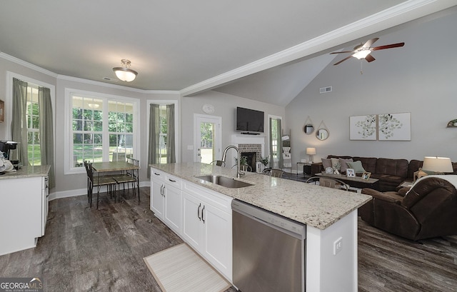 433 Wilson Dr, Mcdonough, GA 30252 - kitchen with dishwasher, open floor plan, a fireplace, light stone counters, and dark wood-style flooring