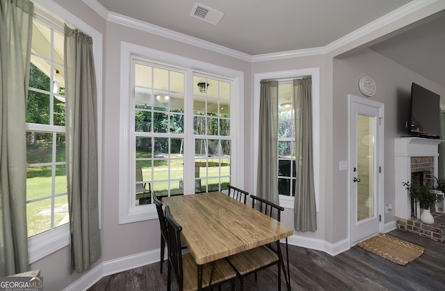 433 Wilson Dr, Mcdonough, GA 30252 - dining space featuring dark wood-style floors, crown molding, and a brick fireplace