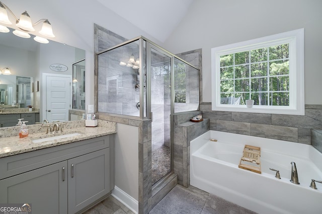 433 Wilson Dr, Mcdonough, GA 30252 - full bathroom with vanity, a bath, a stall shower, and vaulted ceiling