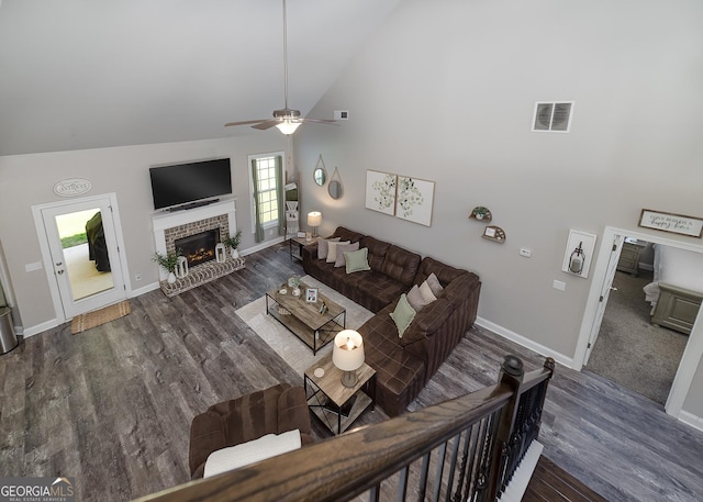 433 Wilson Dr, Mcdonough, GA 30252 - living area featuring high vaulted ceiling, a ceiling fan, wood finished floors, and a brick fireplace