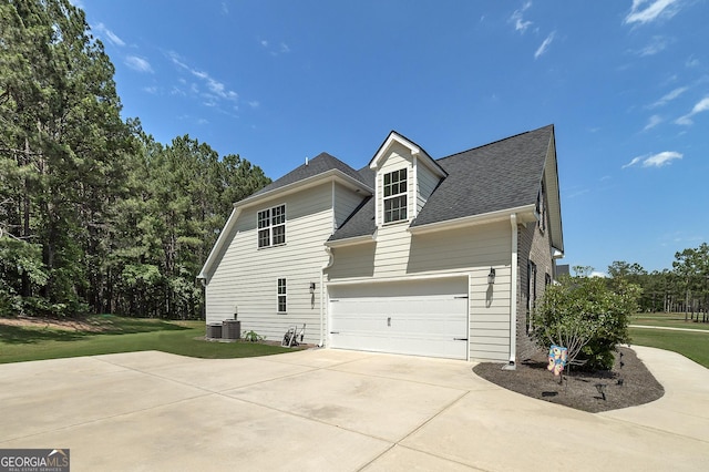 433 Wilson Dr, Mcdonough, GA 30252 - view of side of home with a garage, a shingled roof, concrete driveway, and a lawn