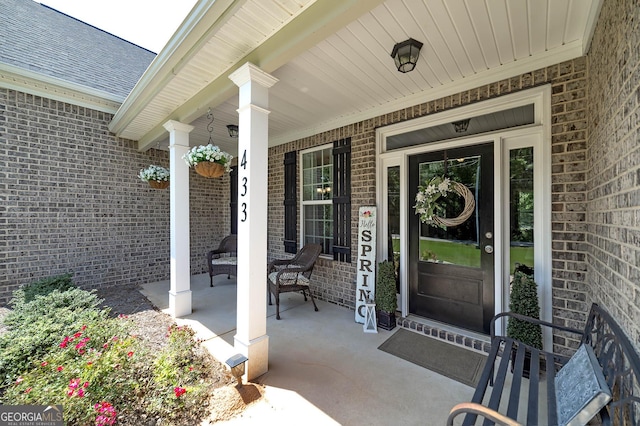 433 Wilson Dr, Mcdonough, GA 30252 - entrance to property featuring brick siding, a porch, and a shingled roof