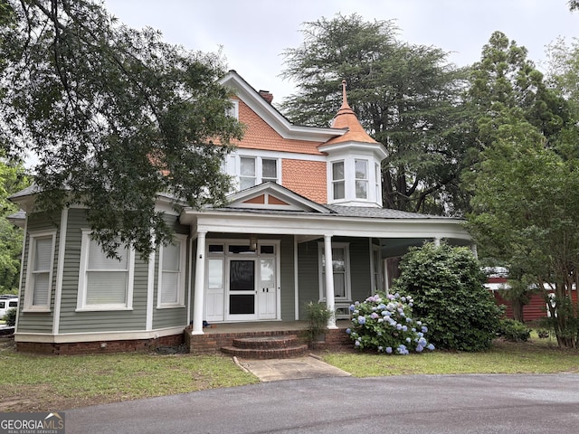 435 Jackson St, Locust Grove, GA 30248 - victorian home featuring a porch and a chimney