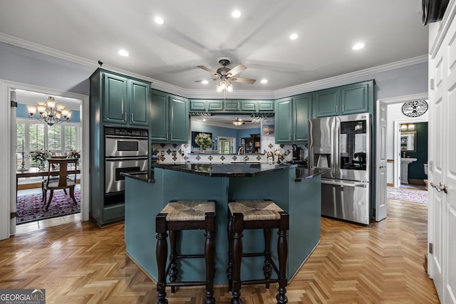 1703 Brandywine Ct, Dunwoody, GA 30338 - kitchen featuring appliances with stainless steel finishes, a ceiling fan, a chandelier, tasteful backsplash, and a breakfast bar