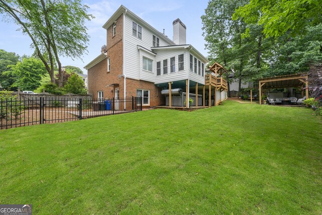 1703 Brandywine Ct, Dunwoody, GA 30338 - back of property with a chimney, brick siding, and a detached carport