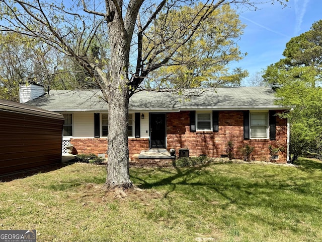 107 Woodhaven Dr, Stockbridge, GA 30281 - ranch-style home with brick siding, a front lawn, roof with shingles, and a chimney