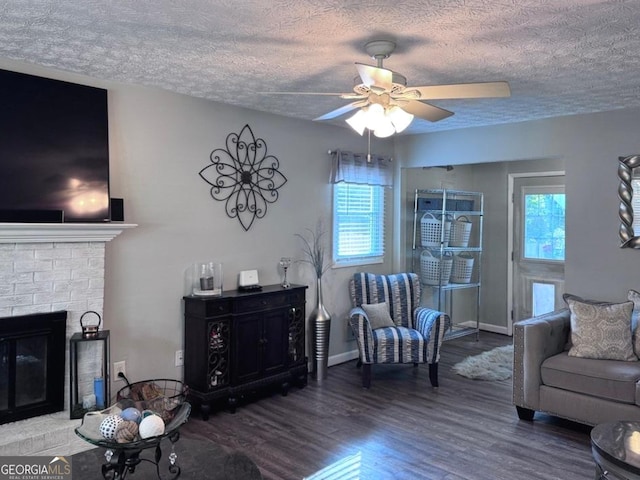 107 Woodhaven Dr, Stockbridge, GA 30281 - living area with wood finished floors, a textured ceiling, ceiling fan, and a fireplace