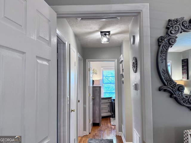 107 Woodhaven Dr, Stockbridge, GA 30281 - hallway with light wood-style floors and a textured ceiling