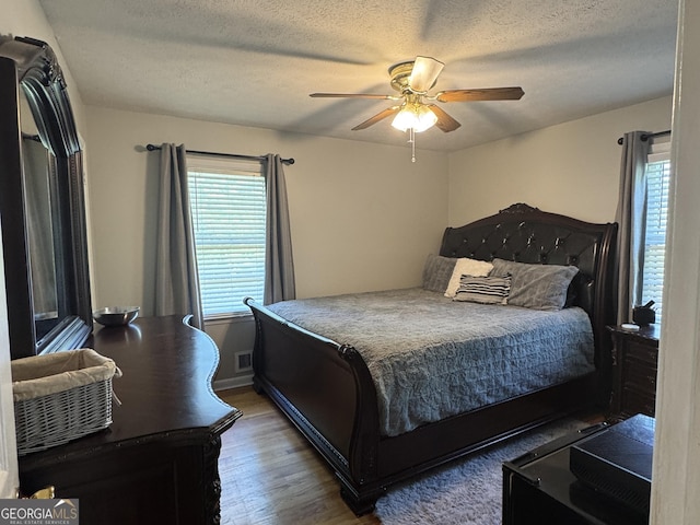 107 Woodhaven Dr, Stockbridge, GA 30281 - bedroom featuring wood finished floors, ceiling fan, and a textured ceiling