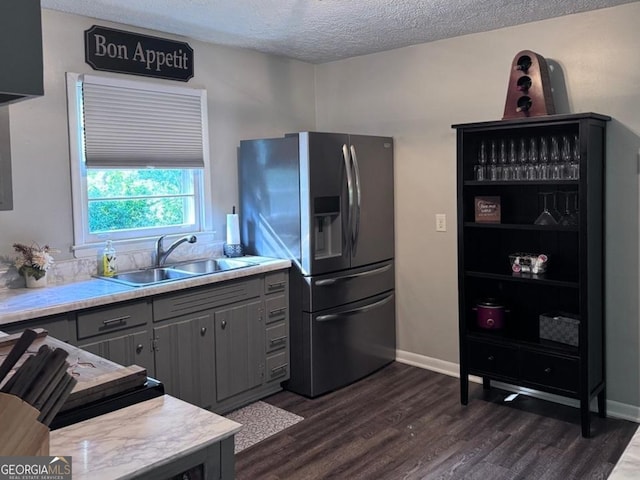 107 Woodhaven Dr, Stockbridge, GA 30281 - kitchen featuring stainless steel fridge with ice dispenser, gray cabinetry, a sink, dark wood finished floors, and light countertops