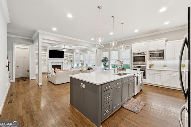 3998 Commodore Dr, Atlanta, GA 30341 - kitchen featuring gray cabinets, stainless steel appliances, a sink, crown molding, and white cabinets