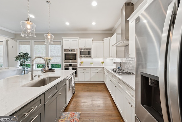 3998 Commodore Dr, Atlanta, GA 30341 - kitchen featuring stainless steel appliances, a sink, gray cabinetry, ornamental molding, and wall chimney exhaust hood