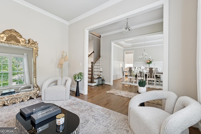 3998 Commodore Dr, Atlanta, GA 30341 - living room featuring stairway, crown molding, wood finished floors, and a chandelier