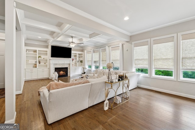 3998 Commodore Dr, Atlanta, GA 30341 - living area featuring a stone fireplace, ceiling fan, baseboards, wood finished floors, and beam ceiling
