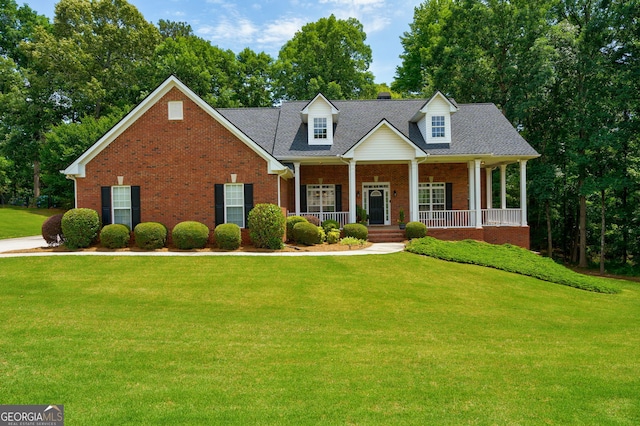 1621 White Oak Cv, Loganville, GA 30052 - view of front of house with brick siding, a front lawn, and covered porch