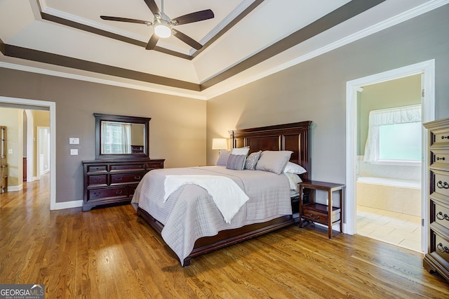 1621 White Oak Cv, Loganville, GA 30052 - bedroom featuring a raised ceiling, ornamental molding, wood finished floors, ensuite bathroom, and ceiling fan
