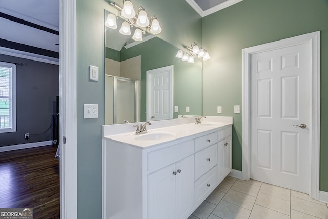 1621 White Oak Cv, Loganville, GA 30052 - full bath with ornamental molding, double vanity, a shower stall, baseboards, and tile patterned flooring