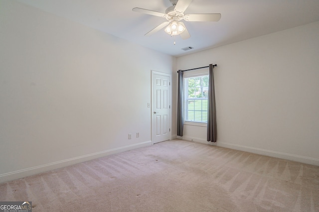 1621 White Oak Cv, Loganville, GA 30052 - empty room featuring light colored carpet, baseboards, and a ceiling fan
