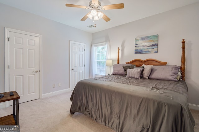 1621 White Oak Cv, Loganville, GA 30052 - bedroom featuring light carpet, baseboards, and ceiling fan